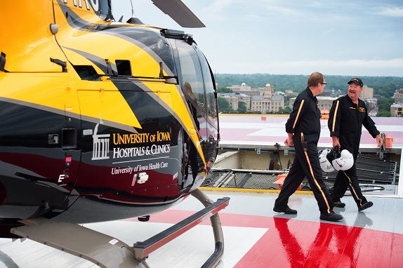 Two people by the UIHC Helicopter