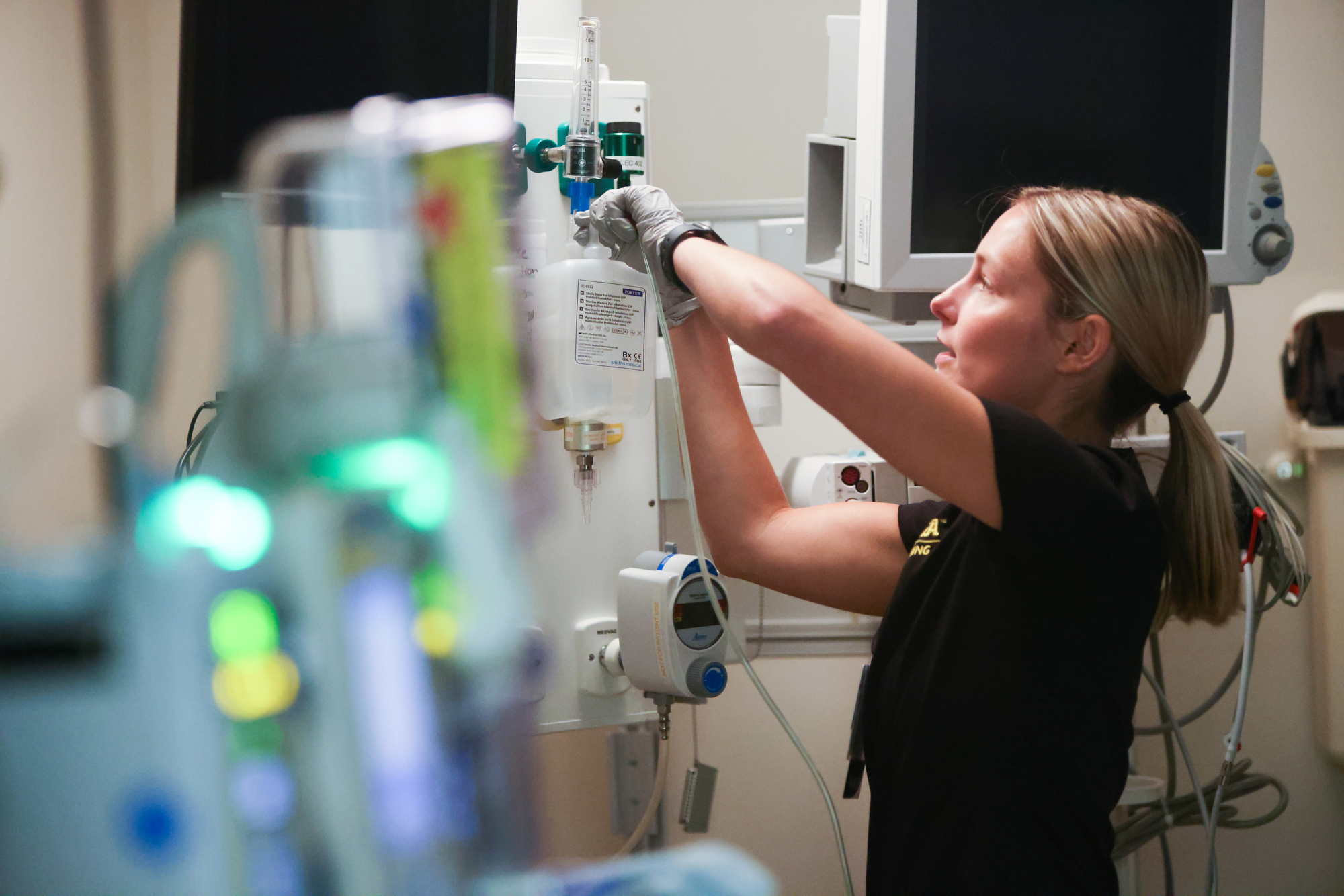 student adjusting IV bag in NCEC